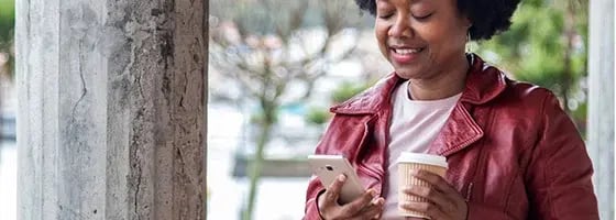 A cafe customer looking at her receipt on her phone