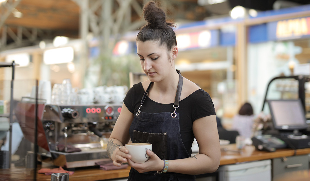 Triniteq - A customer paying for a coffee in a cafe which uses PowerEPOS