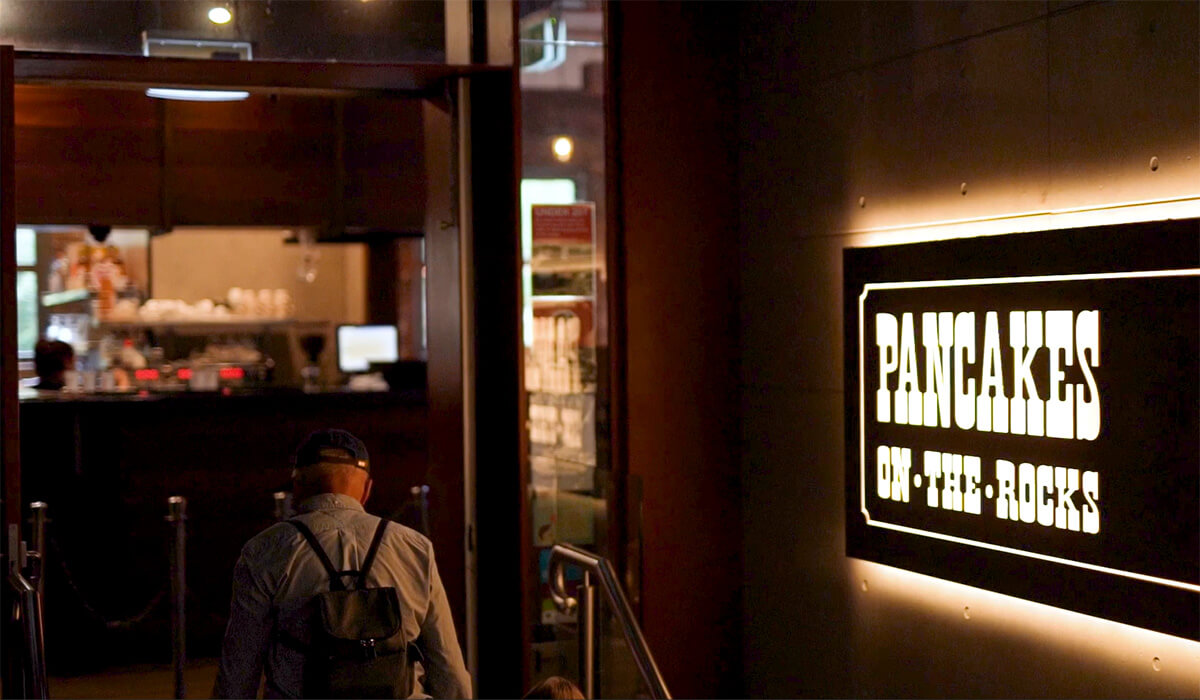 A customer entering Pancakes on the Rocks in Sydney