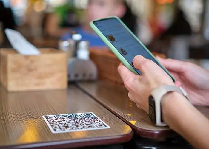 A phone scanning a QR code to place an order