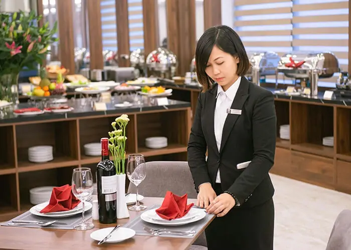 A server setting the table in a restaurant