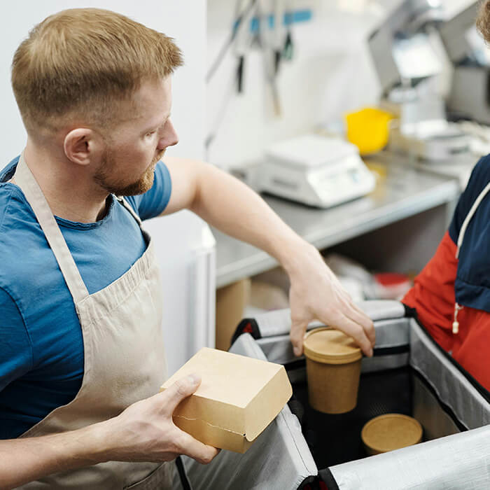 Packing a food in a bag for DoorDash delivery