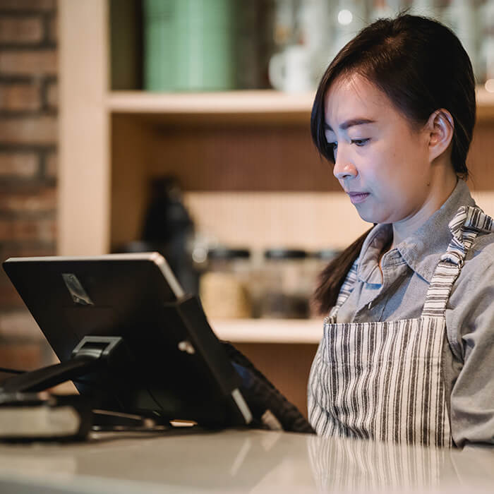 A server in a hotel restaurant using PowerEPOS