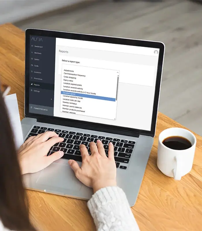 Aura Loyalty admin portal on a laptop