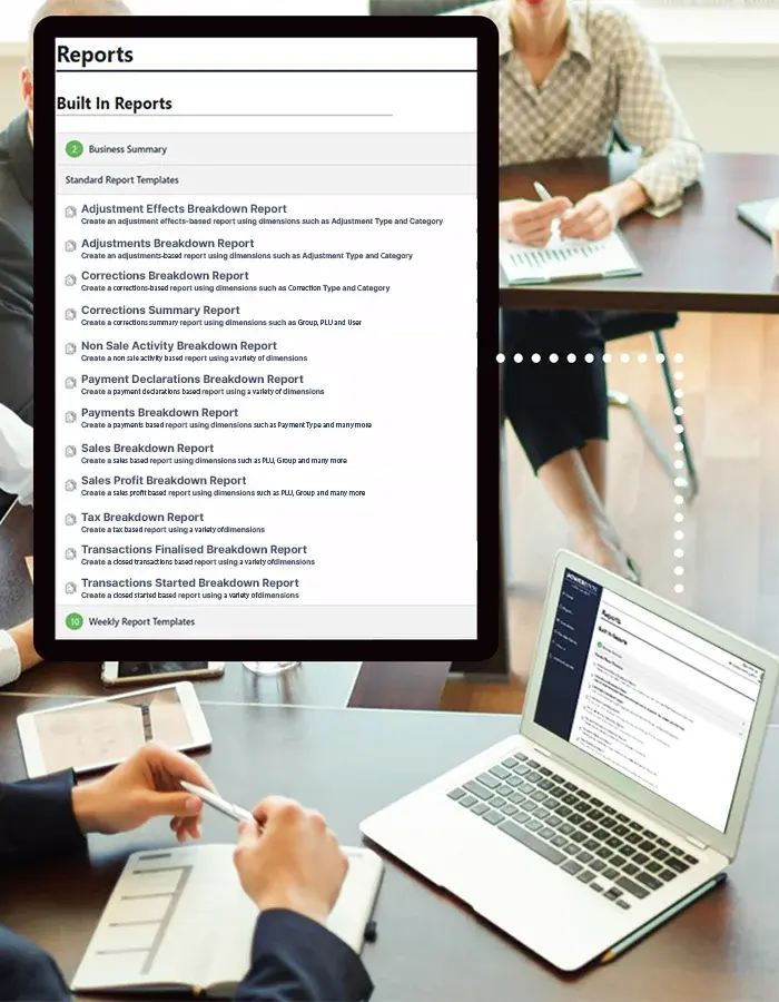 Sales Analyst on a laptop showing built in reports in a board room on