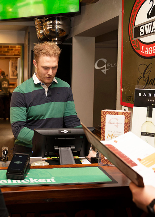 Serving customers in  a pub