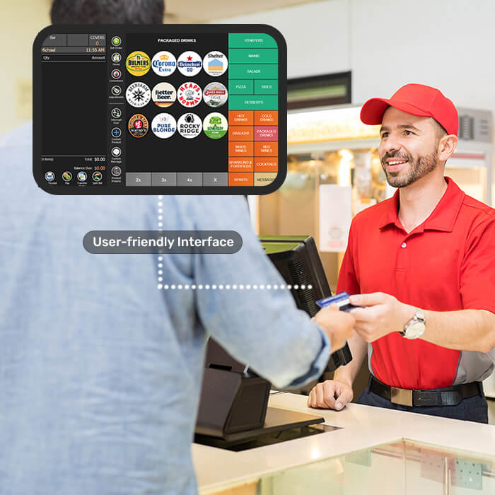 A man handing a credit card over at a stadium food counter.