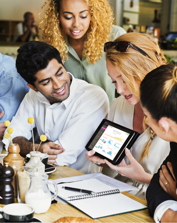 Team members looking at Triniteq Insights on a tablet