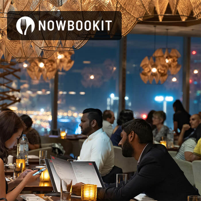 Customers in a busy restaurant looking at the menu