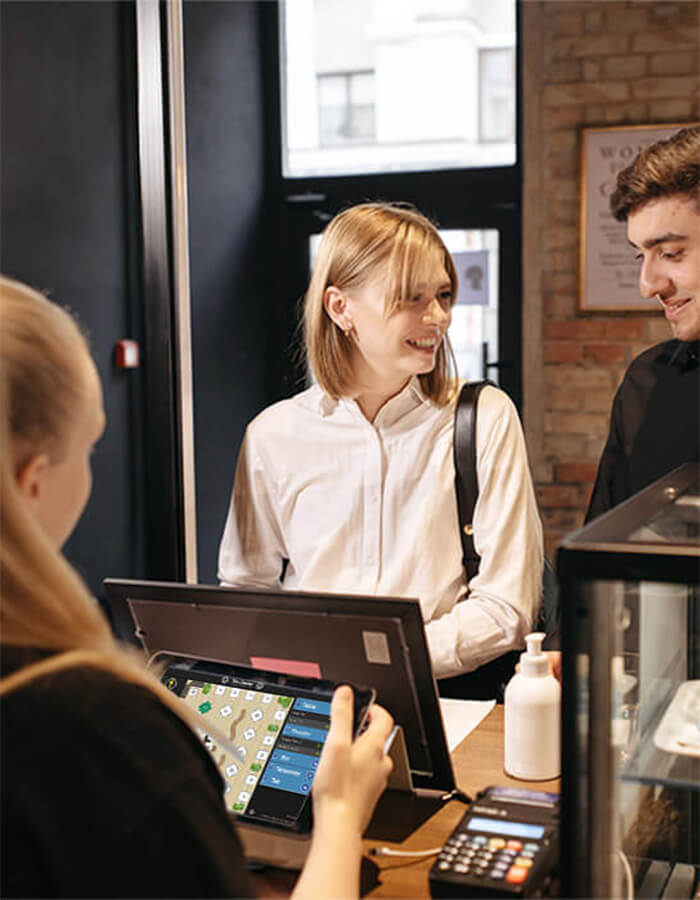 server using PowerEPOS in a hotel cafe